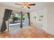 Bright living room with tile flooring, fan, and sliding glass doors to patio at 1606 N Apache Dr, Chandler, AZ 85244