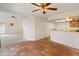 Open-concept living room with ceiling fan, tile floors, and adjacent dining area at 1606 N Apache Dr, Chandler, AZ 85244