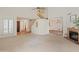 Open living room featuring high ceilings, a cozy fireplace, and seamless flow to other living spaces with views of the staircase at 1606 N Apache Dr, Chandler, AZ 85244
