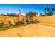 Spacious backyard with lounge chairs, artificial turf, shade umbrellas and a view to mature palm trees at 16602 N 66Th St, Scottsdale, AZ 85254
