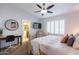 Cozy bedroom featuring plantation shutters, ceiling fan, and views to the bathroom at 16602 N 66Th St, Scottsdale, AZ 85254