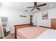 Well-lit bedroom with a wooden bed frame and access to the bathroom at 16602 N 66Th St, Scottsdale, AZ 85254