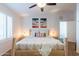 Bright bedroom featuring natural wood furniture, unique artwork, and neutral tones at 16602 N 66Th St, Scottsdale, AZ 85254