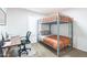 Bedroom with a bunk bed, a desk, a chair, and a window with plantation shutters at 16602 N 66Th St, Scottsdale, AZ 85254