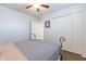 Bedroom featuring a modern ceiling fan, and a light-colored wall, and a closet at 16602 N 66Th St, Scottsdale, AZ 85254