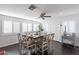 Bright dining room with wood floors, fan, and white-shuttered windows at 16602 N 66Th St, Scottsdale, AZ 85254