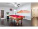 Bright game room features a pool table and dark hardwood floors at 16602 N 66Th St, Scottsdale, AZ 85254