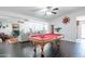 Open game room with a red felt pool table and view into the living and dining areas at 16602 N 66Th St, Scottsdale, AZ 85254