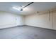Epoxy floored two car garage featuring an automatic garage door opener, white brick walls and good lighting at 16602 N 66Th St, Scottsdale, AZ 85254