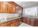 Well-equipped kitchen with dark wood cabinets and granite countertops at 16602 N 66Th St, Scottsdale, AZ 85254