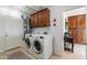 Laundry room featuring modern appliances, storage cabinets, and convenient access to amenities at 16602 N 66Th St, Scottsdale, AZ 85254