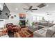 Spacious living room featuring a fireplace, ceiling fan, and a comfortable sectional sofa at 16602 N 66Th St, Scottsdale, AZ 85254