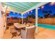 Comfortable covered outdoor patio with lights, table, chairs, grill and view to the swimming pool beyond at 16602 N 66Th St, Scottsdale, AZ 85254