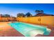 An inviting backyard pool with a safety fence, lush green lawn and a serene ambiance at 16602 N 66Th St, Scottsdale, AZ 85254