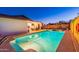 An inviting backyard pool surrounded by a covered patio, lounge chairs, and lush landscaping at 16602 N 66Th St, Scottsdale, AZ 85254