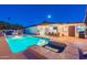 Sparkling backyard pool and spa accented by a covered patio with table and chairs create a relaxing outdoor oasis at 16602 N 66Th St, Scottsdale, AZ 85254