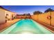 An inviting backyard pool with a patio, lounge chairs, and mature trees provides a relaxing outdoor space at 16602 N 66Th St, Scottsdale, AZ 85254