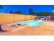 A refreshing backyard pool and spa with a safety fence and lush landscaping creates a serene outdoor retreat at 16602 N 66Th St, Scottsdale, AZ 85254