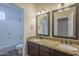 Bathroom showcasing a dual sink vanity with granite counters and a tub and shower combo at 1826 W Oriole Way, Chandler, AZ 85286