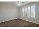 Bedroom with a carpet, ceiling fan, and natural light from a window with plantation shutters at 1826 W Oriole Way, Chandler, AZ 85286