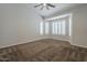 Large carpeted bedroom, featuring bright, plantation shuttered windows and ceiling fan at 1826 W Oriole Way, Chandler, AZ 85286