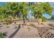 Attractive community entrance with lush landscaping, mature trees, boulders and native vegetation at 1826 W Oriole Way, Chandler, AZ 85286