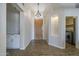 Bright foyer featuring a wood-look floor, modern lighting, and seamless access to other rooms at 1826 W Oriole Way, Chandler, AZ 85286