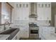 Modern kitchen with stainless steel range, marble countertops, and undermount sink at 1826 W Oriole Way, Chandler, AZ 85286