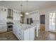 Bright kitchen with island, stainless appliances, and access to a rear room at 1826 W Oriole Way, Chandler, AZ 85286