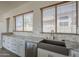 Kitchen with stainless steel sink, marble countertops, tile backsplash, and wood-look flooring at 1826 W Oriole Way, Chandler, AZ 85286