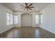 Spacious living room with wood-look flooring, ceiling fan, recessed lights, and large windows at 1826 W Oriole Way, Chandler, AZ 85286
