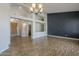 Open-concept living room featuring high ceilings, wood-look floors, designer accent wall, and modern lighting at 1826 W Oriole Way, Chandler, AZ 85286