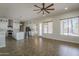 Open floor plan featuring living room and kitchen with stainless steel appliances and wood-look flooring at 1826 W Oriole Way, Chandler, AZ 85286