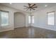 Living room with wood-look flooring, ceiling fan, recessed lighting, and three large windows at 1826 W Oriole Way, Chandler, AZ 85286