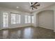 Living room with wood-look floors, large windows, ceiling fan, and recessed lighting at 1826 W Oriole Way, Chandler, AZ 85286