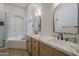 Elegant bathroom boasts double sinks, granite counters, and a soaking tub at 1826 W Oriole Way, Chandler, AZ 85286