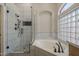 Luxurious bathroom featuring a separate shower and corner soaking tub at 1826 W Oriole Way, Chandler, AZ 85286