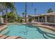 Backyard pool and patio area featuring lush landscaping and several palm trees at 1826 W Oriole Way, Chandler, AZ 85286