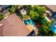 Backyard with a private pool, mature trees, fire pit and lush landscaping; an oasis for relaxation and entertainment at 18402 E Oak Hill Ln, Queen Creek, AZ 85142