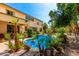 Backyard pool surrounded by lush tropical landscaping and rock features for a relaxing atmosphere at 18402 E Oak Hill Ln, Queen Creek, AZ 85142