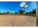 Community basketball court under a clear blue sky with well-maintained concrete and sturdy basketball hoops at 18402 E Oak Hill Ln, Queen Creek, AZ 85142