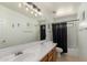 Bright bathroom with double sinks and a shower-tub combo at 18402 E Oak Hill Ln, Queen Creek, AZ 85142