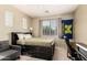 Bedroom with a dark bedframe, writing desk, and school flag at 18402 E Oak Hill Ln, Queen Creek, AZ 85142