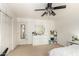 Bright bedroom featuring a dresser, closet, ceiling fan and neutral decor at 18402 E Oak Hill Ln, Queen Creek, AZ 85142