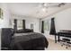 Bright bedroom with carpeted floors and a black bed and black furnishings at 18402 E Oak Hill Ln, Queen Creek, AZ 85142