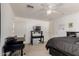 Bright bedroom with carpeted floors and a black bed and black furnishings at 18402 E Oak Hill Ln, Queen Creek, AZ 85142