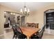 Dining room with wood table, chandelier, and archway into another living space at 18402 E Oak Hill Ln, Queen Creek, AZ 85142