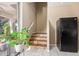 This entryway offers tiled stairs, an adjacent black refrigerator, and natural light from a sliding glass door at 18402 E Oak Hill Ln, Queen Creek, AZ 85142