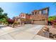 Charming two-story home with stone accents, three-car garage and mature landscaping at 18402 E Oak Hill Ln, Queen Creek, AZ 85142