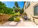 Well-maintained exterior and landscaping featuring a variety of lush trees and colorful bougainvillea at 18402 E Oak Hill Ln, Queen Creek, AZ 85142